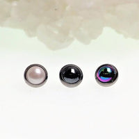 Black pearlescent titanium screw top body clicker with 16g gauge, featuring a sleek, shiny finish and secure closure.