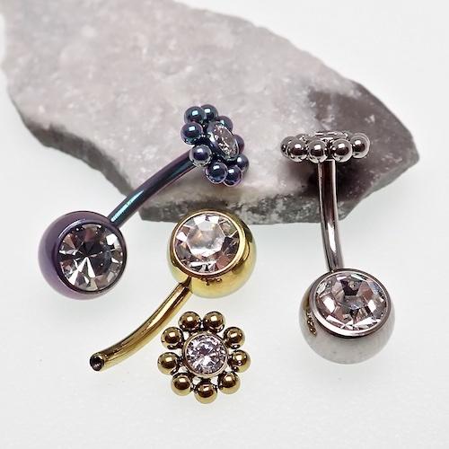 Beaded CZ flower and ball belly bar in 14g body jewelry by Body Clickers with decorative beads and floral design.