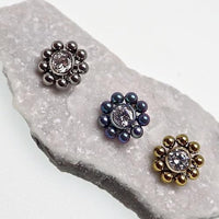 Beaded CZ flower and ball belly bar body jewelry in 14g with decorative flower and bead details.