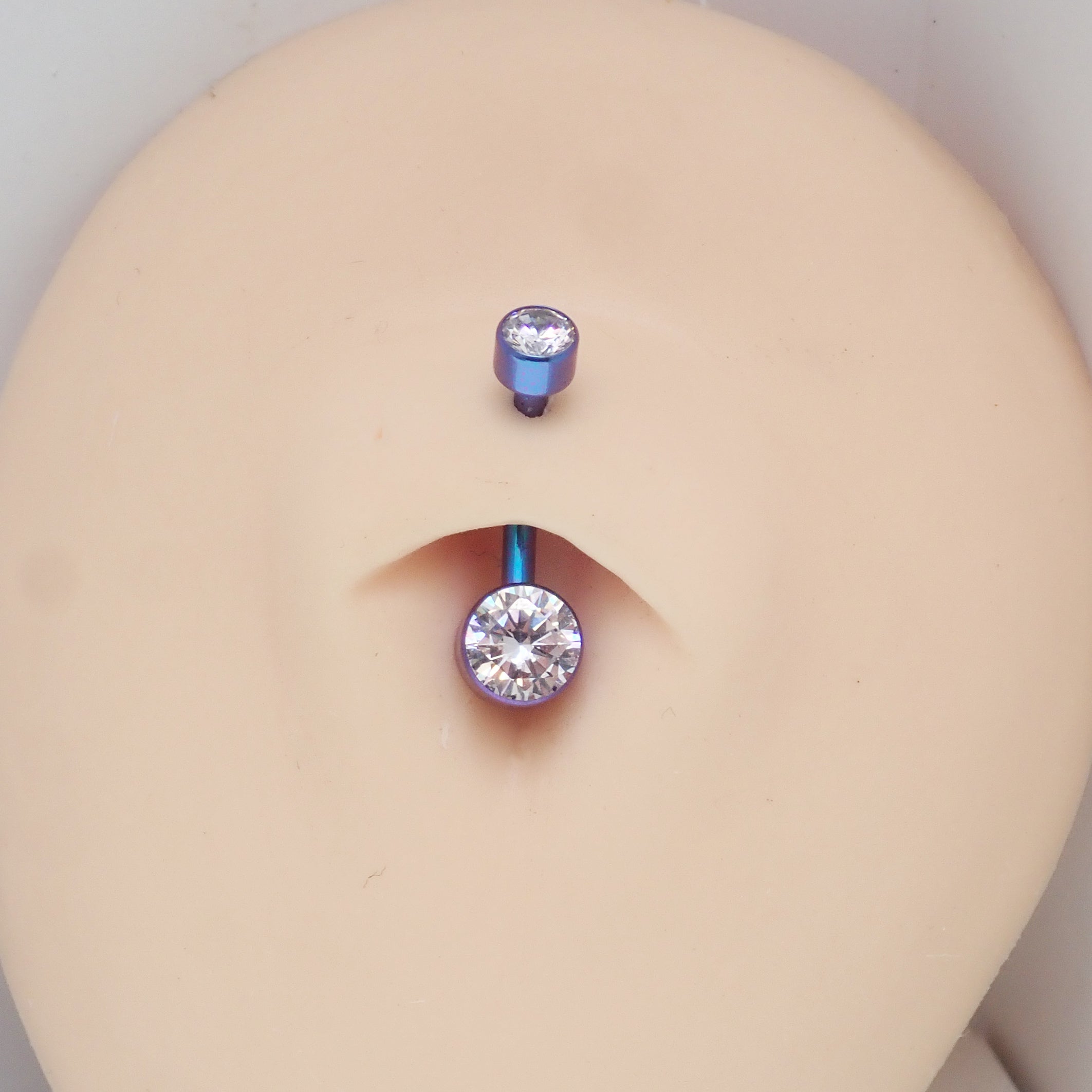 Silver CZ bezel belly bar jewelry by Body Clickers with a 14g body jewelry design for navel piercing.
