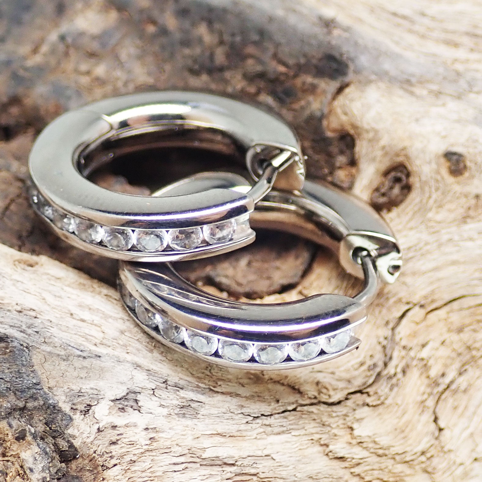 Titanium hinged hoop earrings from Body Clickers, 10mm body jewelry, shiny silver-tone design with smooth hinges.