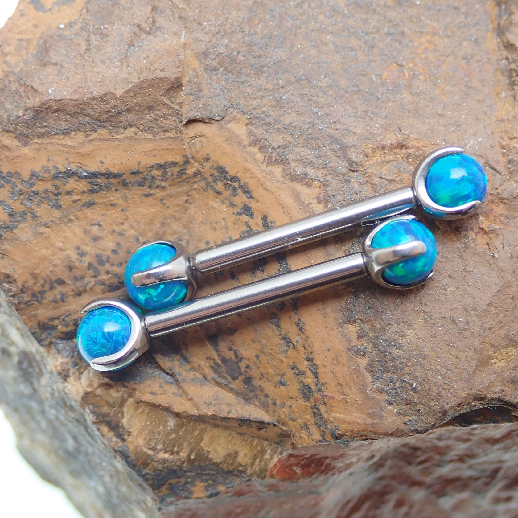 Peacock blue opal titanium nipple bar by Body Clickers Body Jewelry, 12 gauge, 12mm length with decorative gemstone.