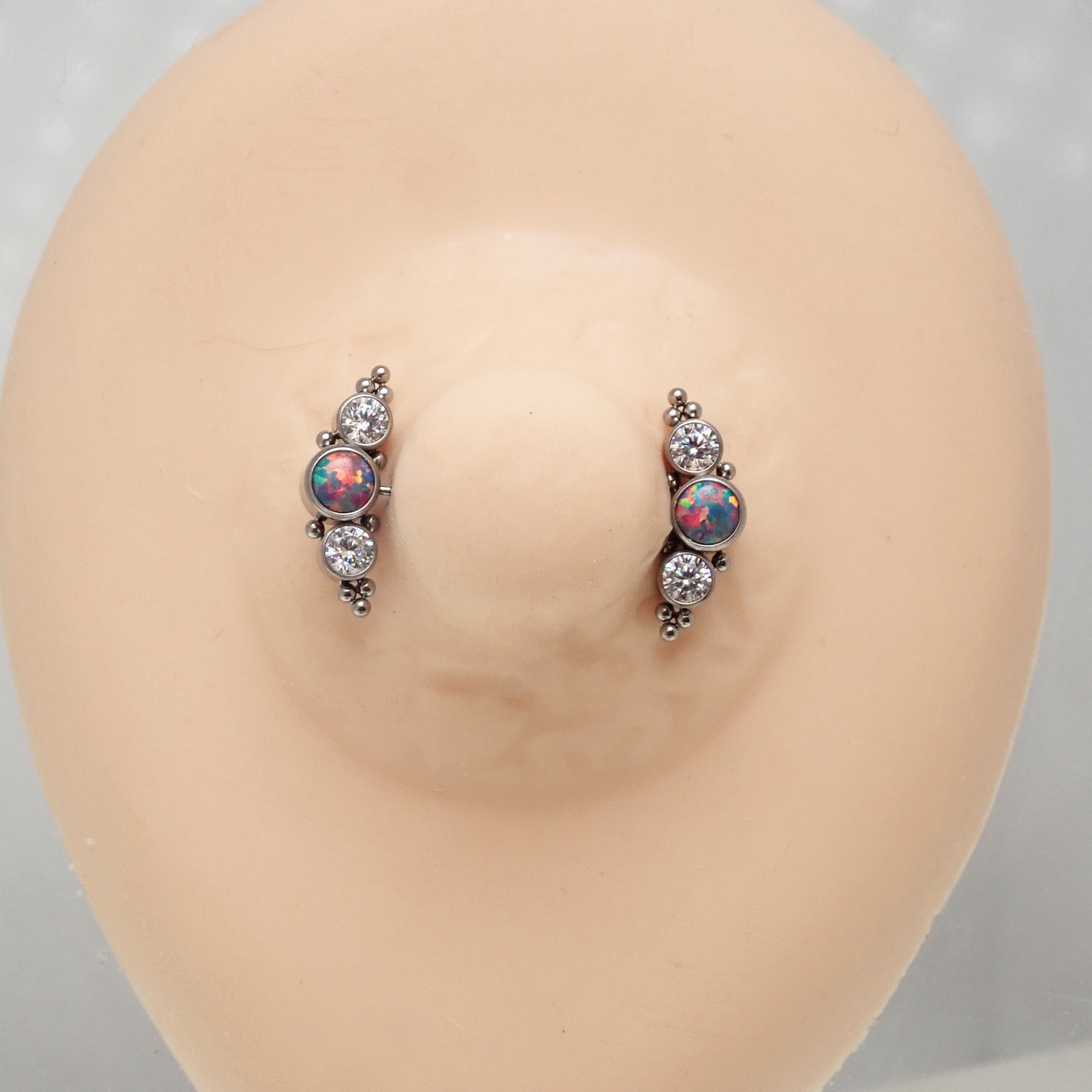 Multi lavender opal and clear CZ push fit nipple bar in 14g body jewelry by Body Clickers, showing the jewelry in detail.