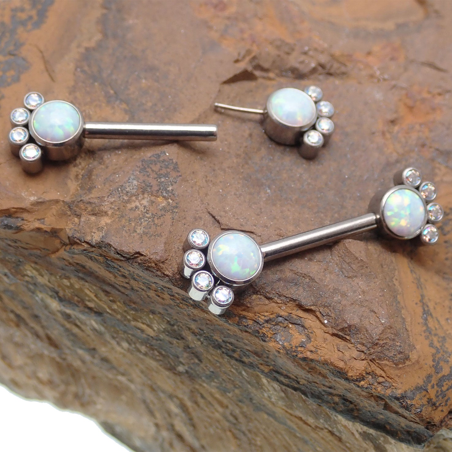 Body Clickers paw print CZ and white opal nipple bar, 14g body jewelry with decorative paw print design.