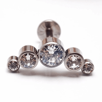 Clear CZ push fit cluster flatback body jewelry in 14g, 16g, 18g, 20g sizes by Body Clickers, featuring sparkling gemstone details.