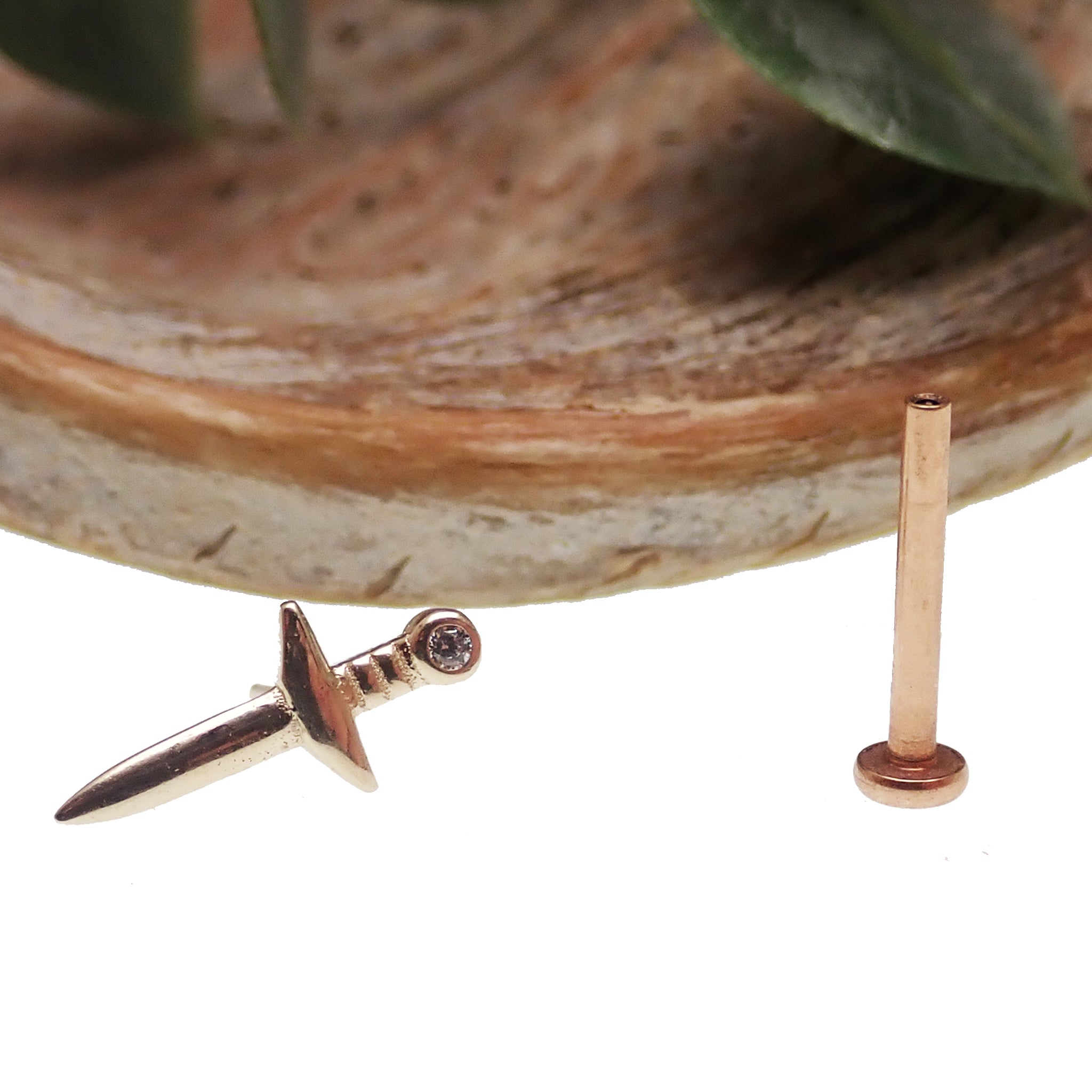 14k gold flat back dagger body jewelry by Body Clickers in 14g, 16g, 18g, and 20g sizes, shown in the image.