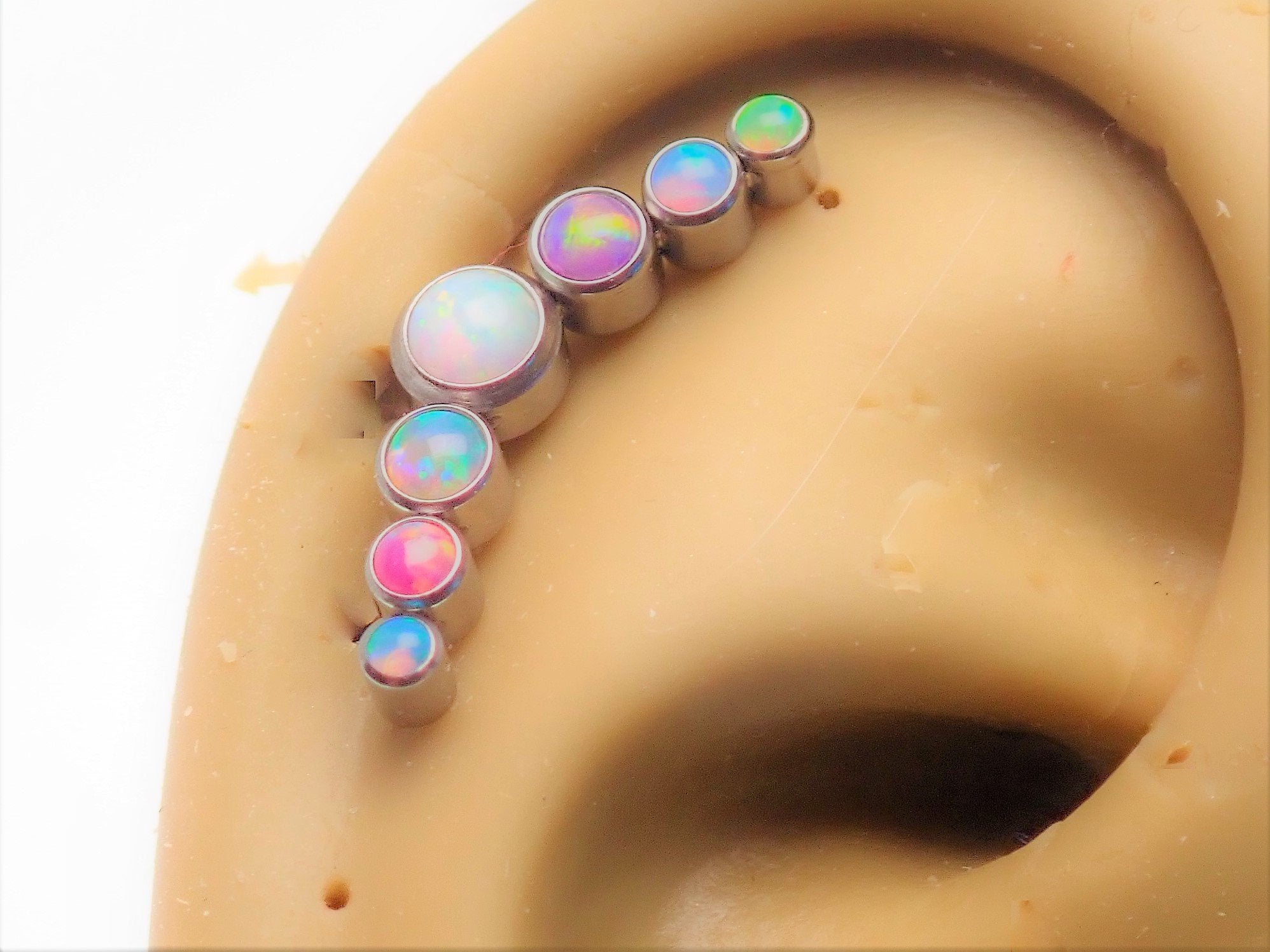 Pastel 7-cluster flatback body piercing jewelry by Body Clickers in 14g, 16g, and 18g gauges, featuring a sleek flatback design.