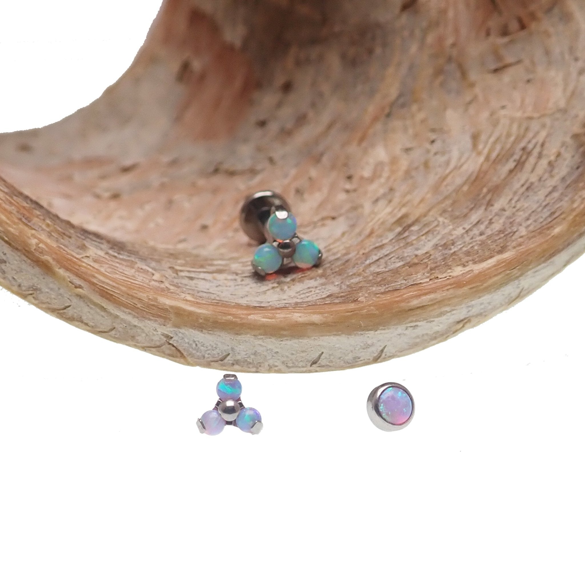 Set of three Body Clickers body jewelry with angel opal and bubblegum opal clusters in 14g, 16g, and 18g sizes.