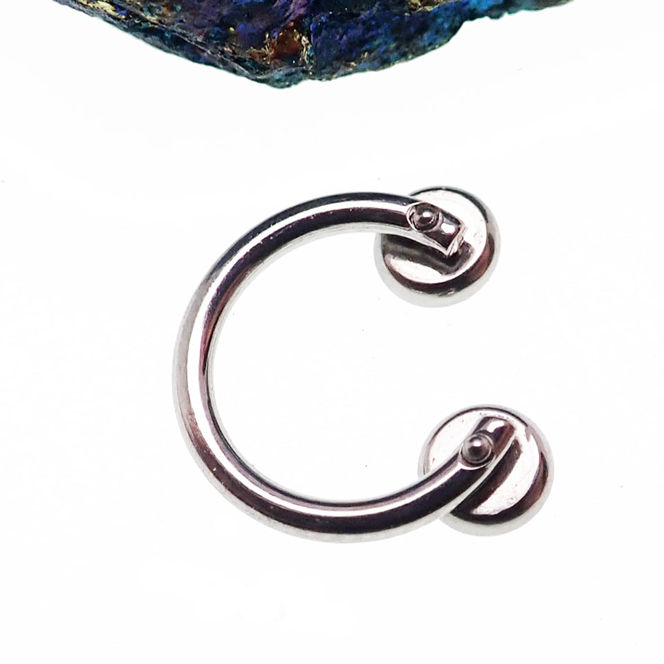 Titanium Zircon blue crystal horseshoe body jewelry with 14g gauge and 8mm size, featuring a sparkling blue crystal design.