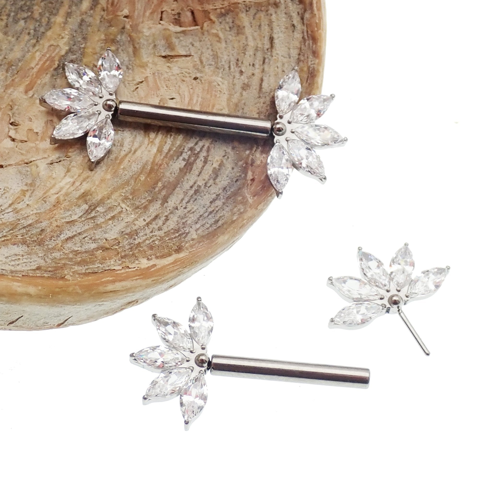 Clear CZ flower titanium nipple barbell in 16g and 14g with a floral design, body jewelry by Body Clickers.