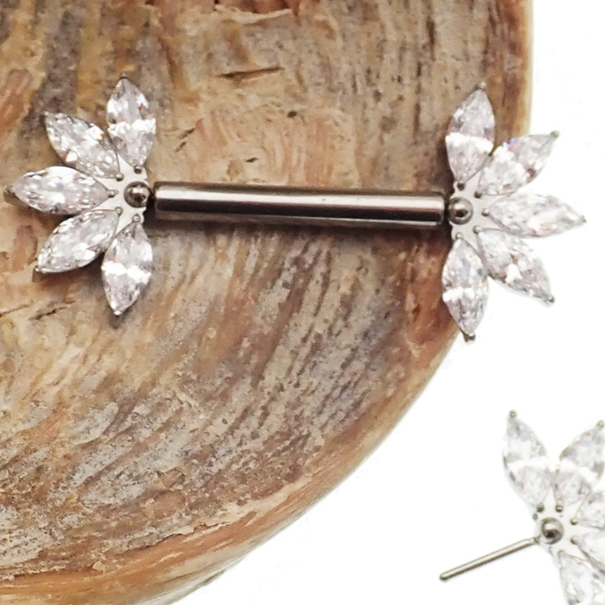 Clear CZ flower titanium nipple barbell in 16g and 14g, Body Clickers body jewelry with a floral design and sparkling stones.
