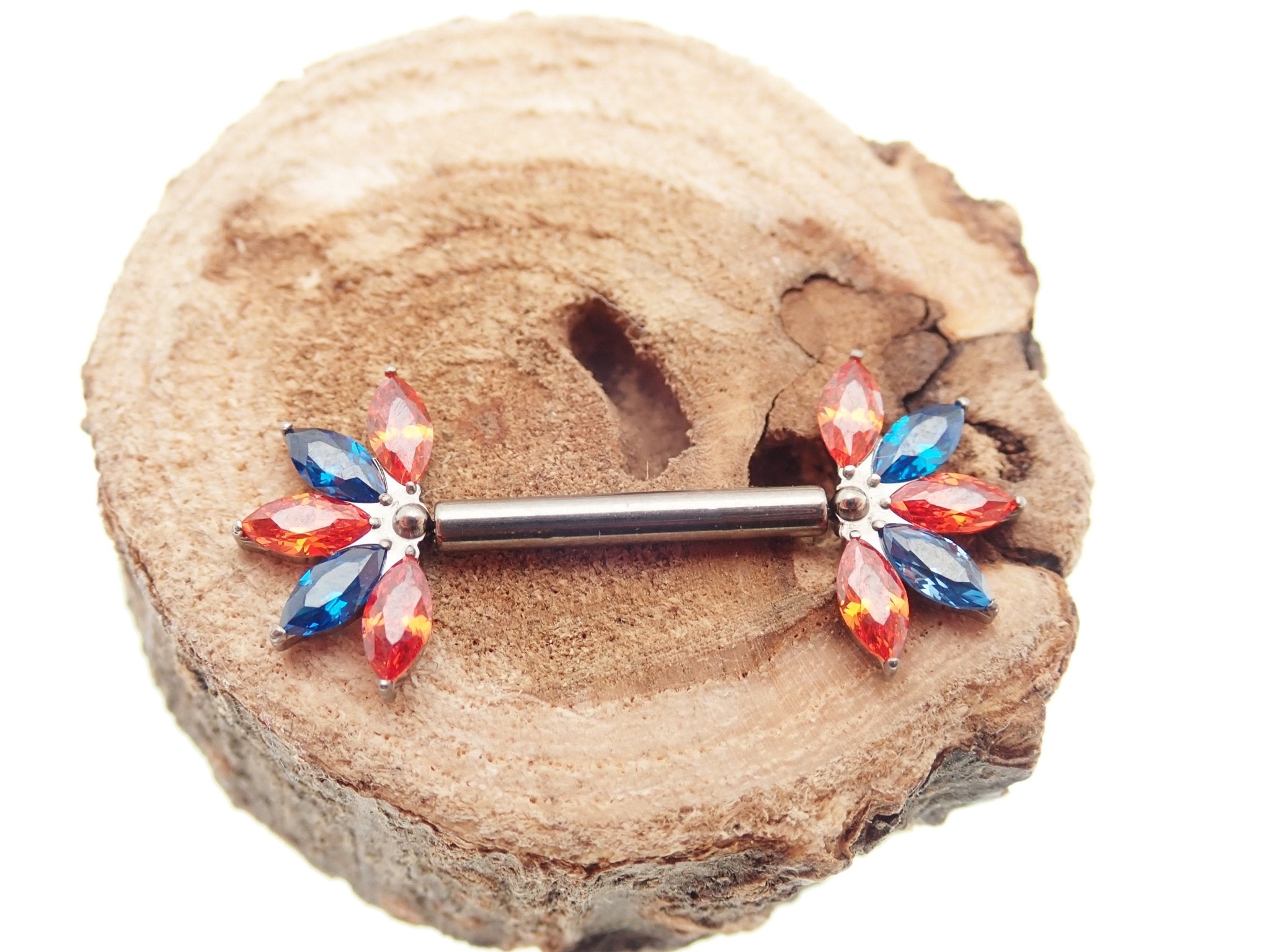 Orange and blue CZ flower titanium nipple bar in 12g, 14g, and 16g from Body Clickers body jewelry collection.