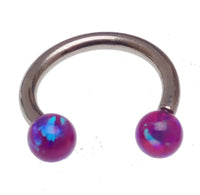 Body Clickers horseshoe body jewelry with 16g and 18g yellow opal ends, featuring a moon-shaped design.