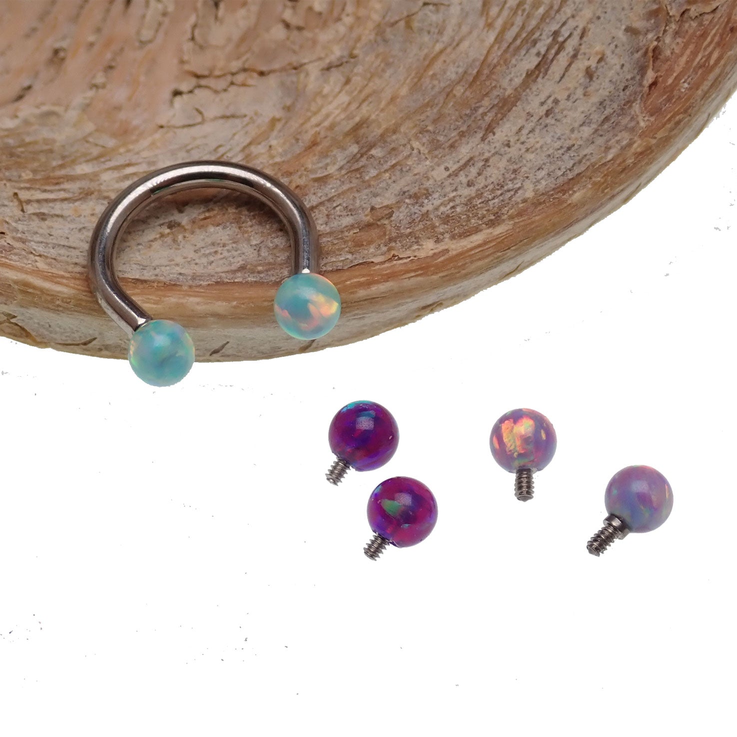 Body Clickers horseshoe body jewelry with yellow opal ends, available in 16g and 18g sizes, featuring moon-shaped designs.