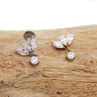 Small flower dangle body jewelry by Body Clickers, titanium flatback design in 14g, 16g, and 18g sizes with 6mm flower charm.