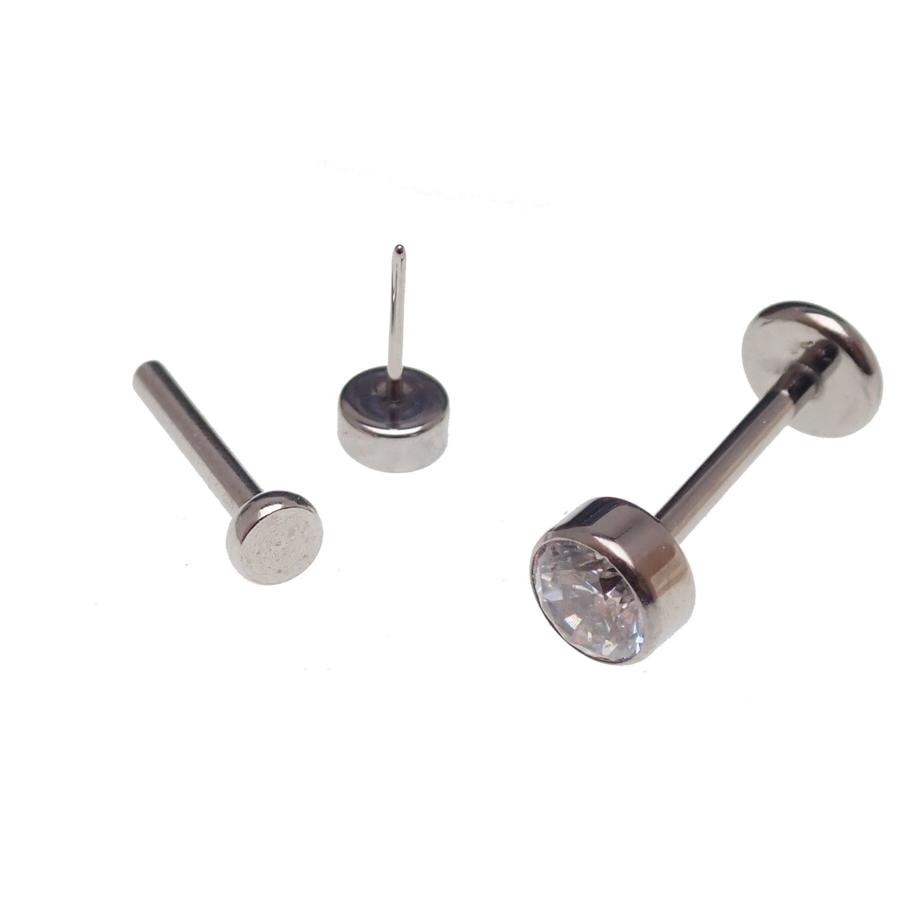 Clear CZ titanium push fit flat back body jewelry in 14g, 16g, 18g, or 20g with 6mm diameter and 2mm thickness.