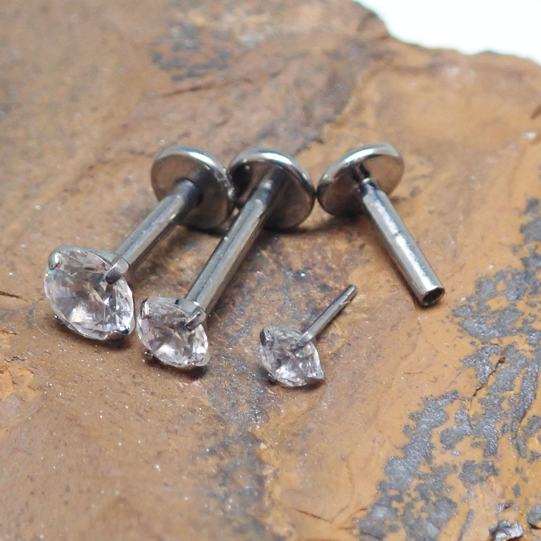 Push Fit Crystal flat back labret body jewelry by Body Clickers in 3, 4, and 5mm sizes, featuring a crystal accent and flat back design.