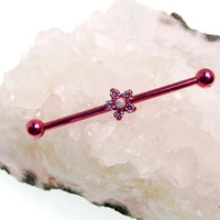 Titanium drilled industrial body jewelry with flower design in 14g from Body Clickers, showing the pierced industrial bar with floral detail.