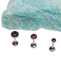 Black cherry opal flat back body jewelry piercing in 14g, 16g, or 18g by Body Clickers, showcasing the smooth, polished design.