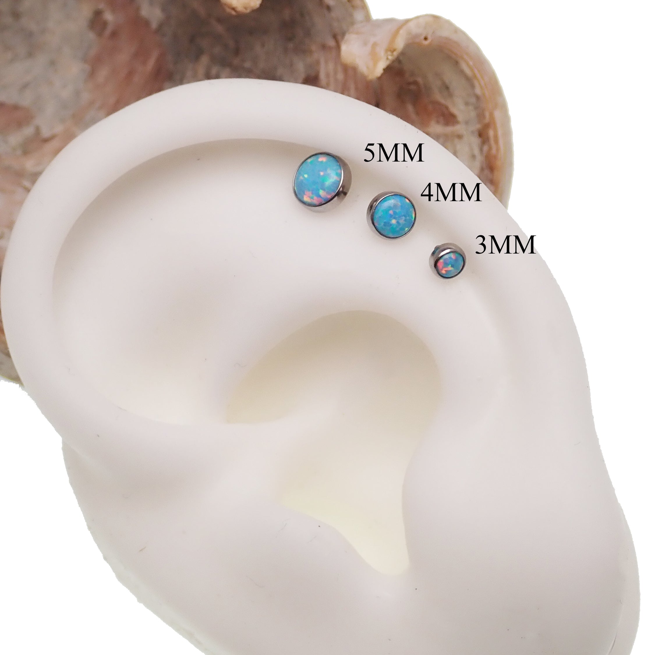 Blue mint opal flat back body piercing jewelry by Body Clickers in 14g, 16g, and 18g gauges, shown on a helix piercing.