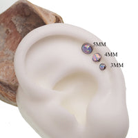 Unicorn Opal flat back body piercing by Body Clickers in 14g, 16g, 18g with colorful gemstone and silver-tone body jewelry.