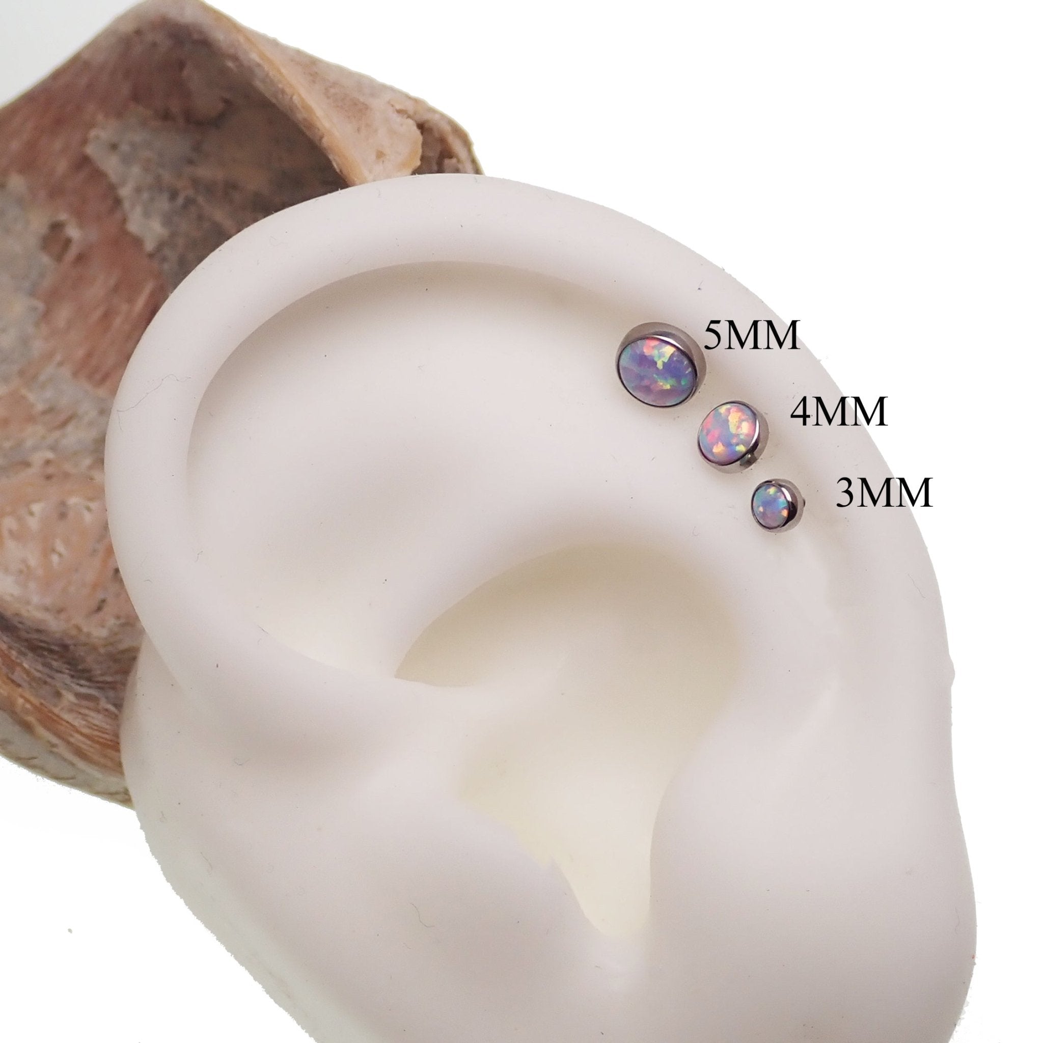 Unicorn Opal flat back body piercing by Body Clickers in 14g, 16g, 18g with colorful gemstone and silver-tone body jewelry.