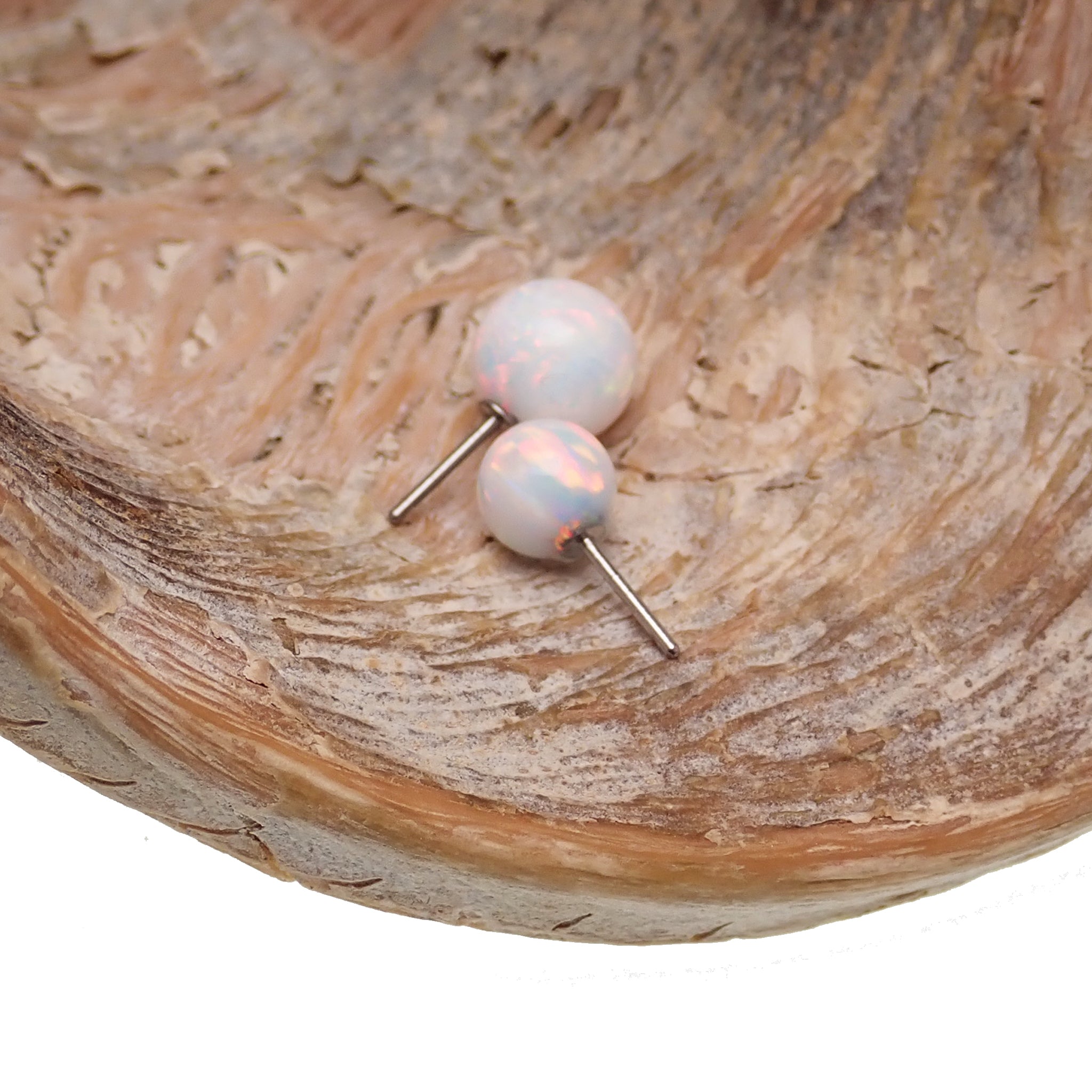 White opal push fit ball attachment for body jewelry by Body Clickers, 4mm, featuring a smooth, shiny white opal stone.