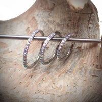 Sparkly AB titanium CZ clicker body jewelry in 16g with 6mm diameter, featuring sparkling cubic zirconia stones.