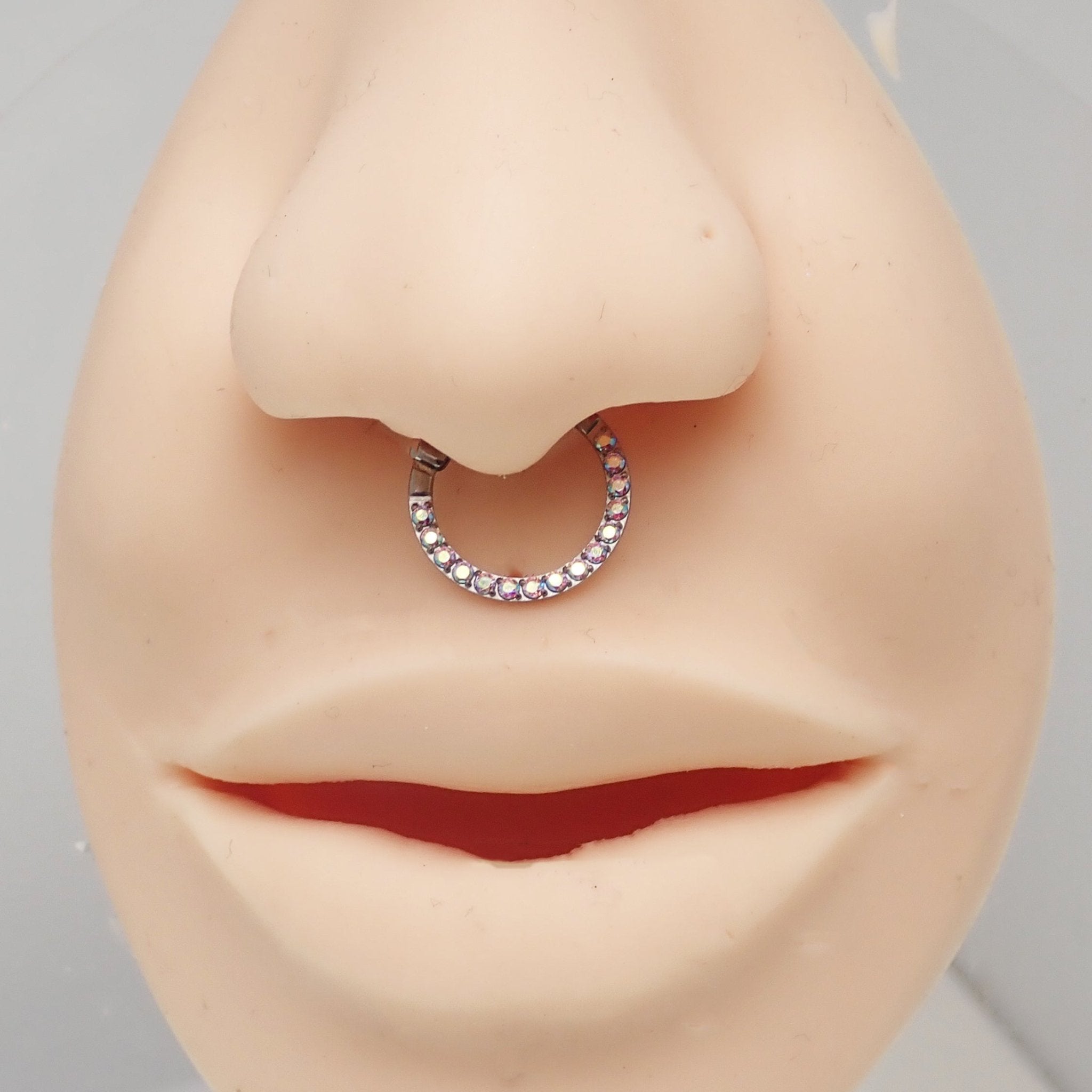 Titanium clicker body jewelry featuring Aurora Borealis CZ stones, designed for septum piercing, by Body Clickers.