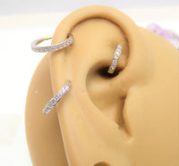 CZ inlaid thick steel hoop body jewelry, 16g gauge, by Body Clickers, featuring shiny cubic zirconia accents and durable steel construction.
