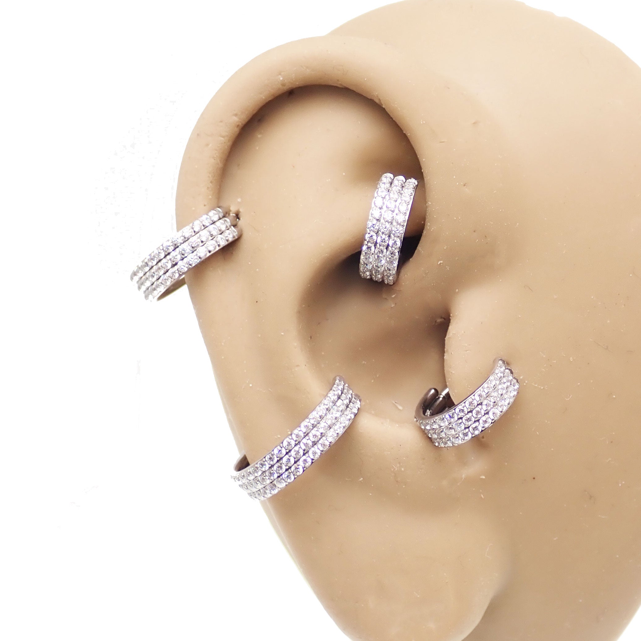 Three-layer zircon clicker body jewelry in 16g with a sleek design, featuring sparkling zircon stones on a stainless steel body.