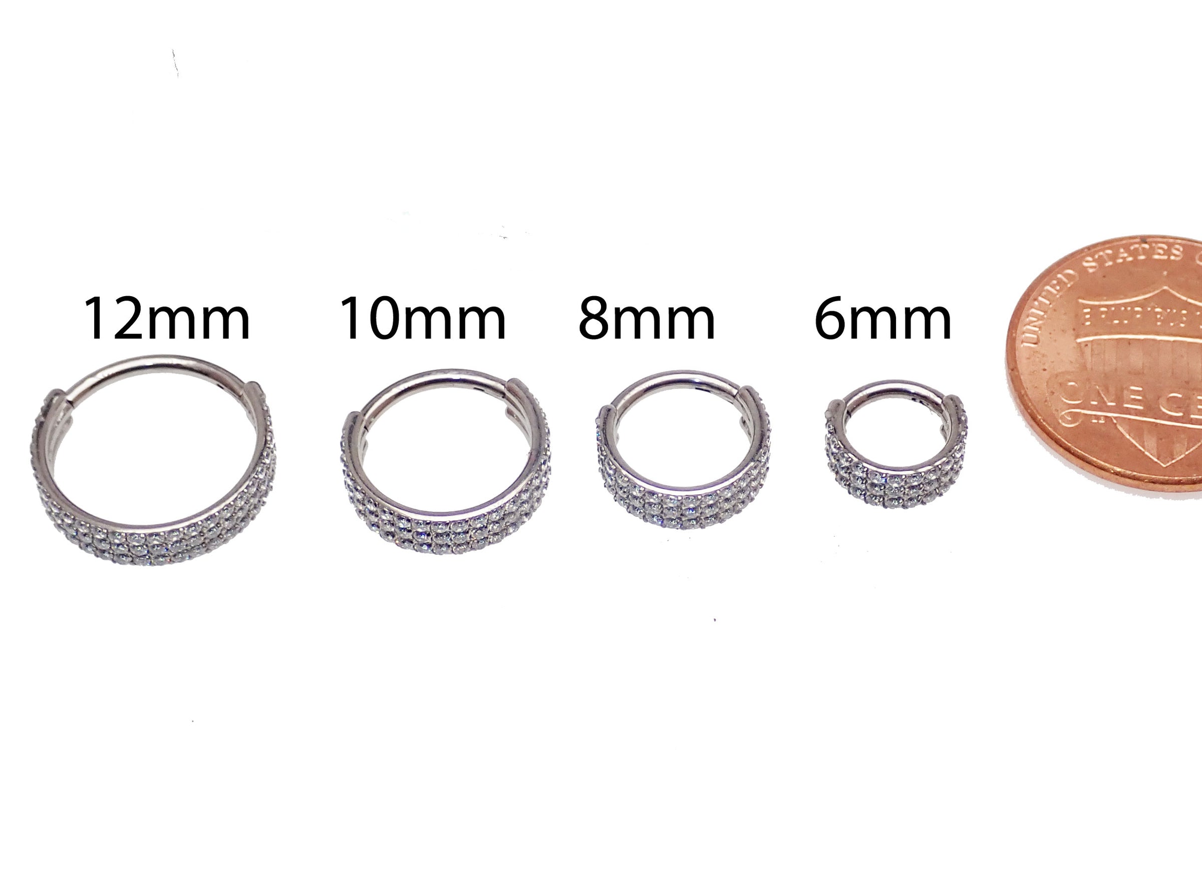 Three-layer zircon clicker body jewelry in 16g with a 6mm inner diameter, featuring sparkling zircon stones on a sleek clicker design.