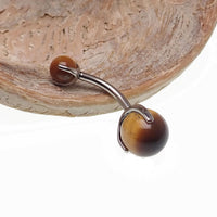 Titanium belly ring featuring a 6mm real Tigers Eye stone, Body Clickers Body Jewelry, showcasing a polished, smooth gemstone setting.
