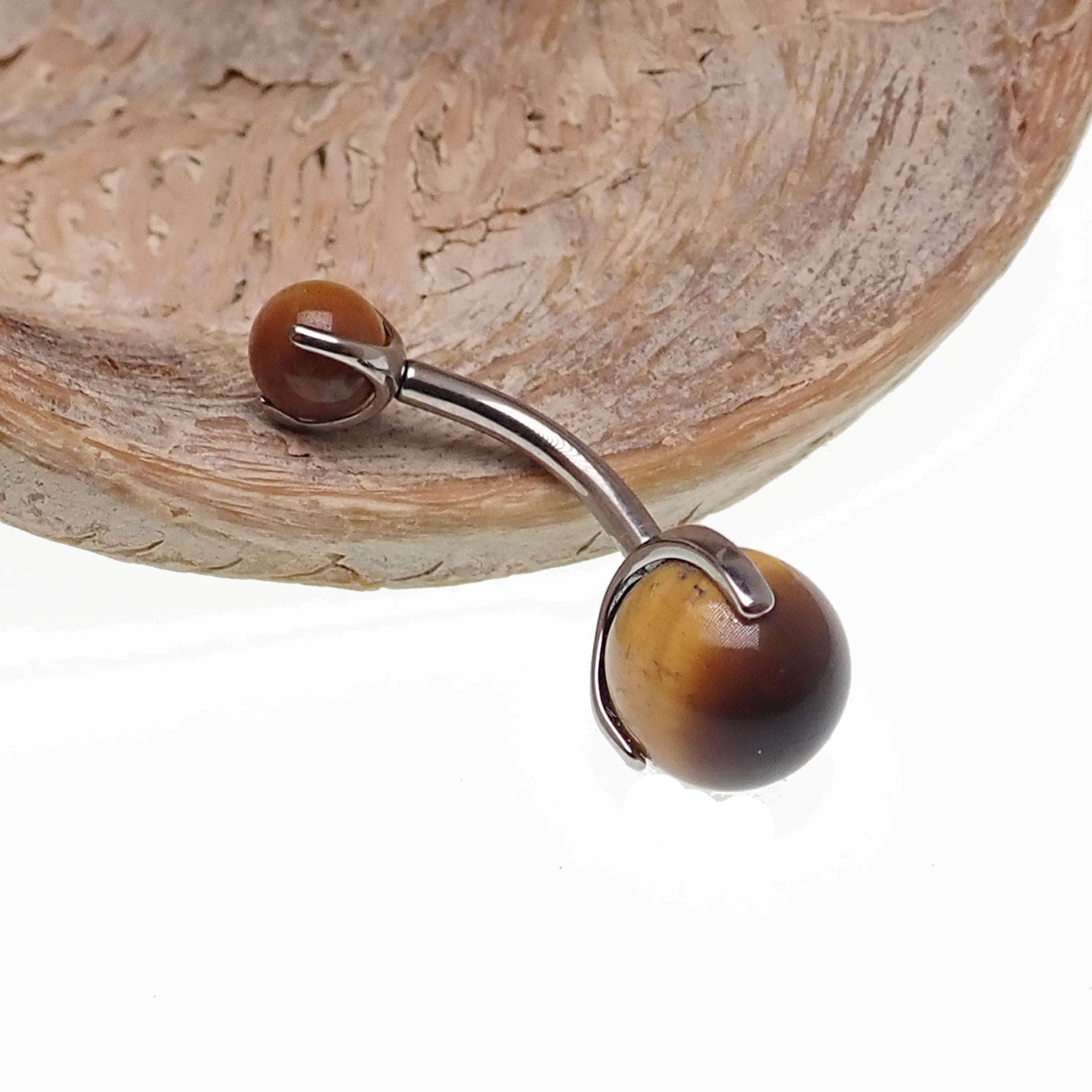Titanium belly ring featuring a 6mm real Tigers Eye stone, Body Clickers Body Jewelry, showcasing a polished, smooth gemstone setting.