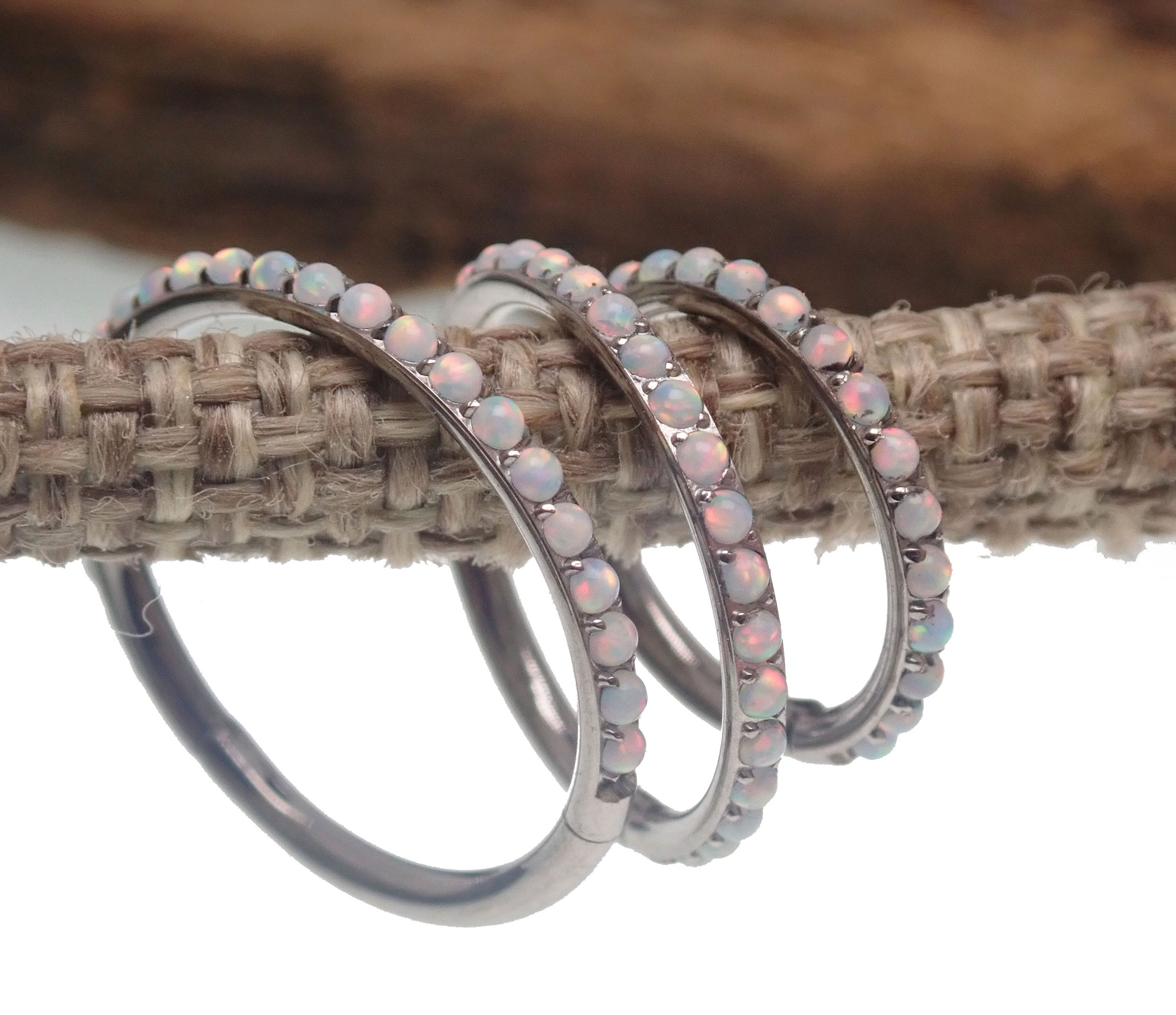 White fire opal titanium clicker body jewelry in 16g with 6mm gemstone, designed for piercings by Body Clickers.