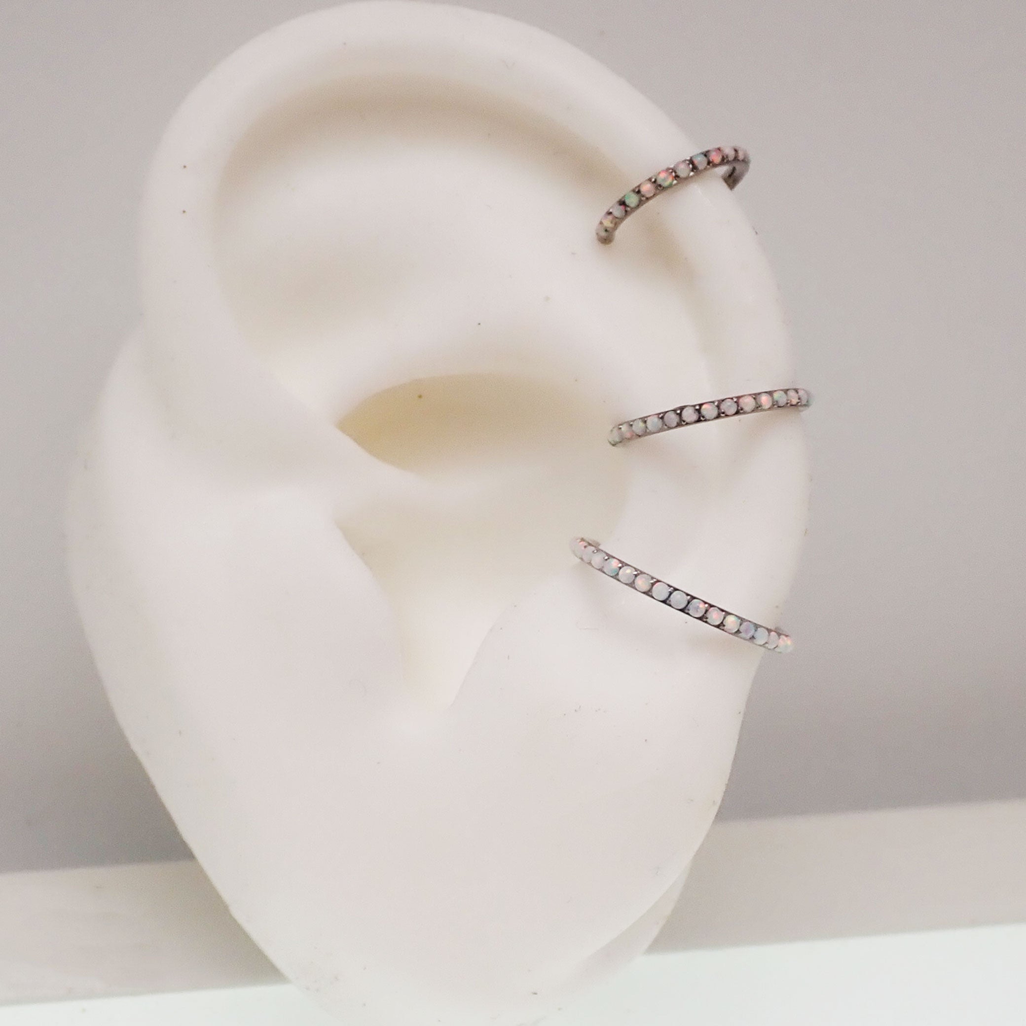 White fire opal titanium clicker body jewelry in 16g with 6mm gemstone for piercing adornment