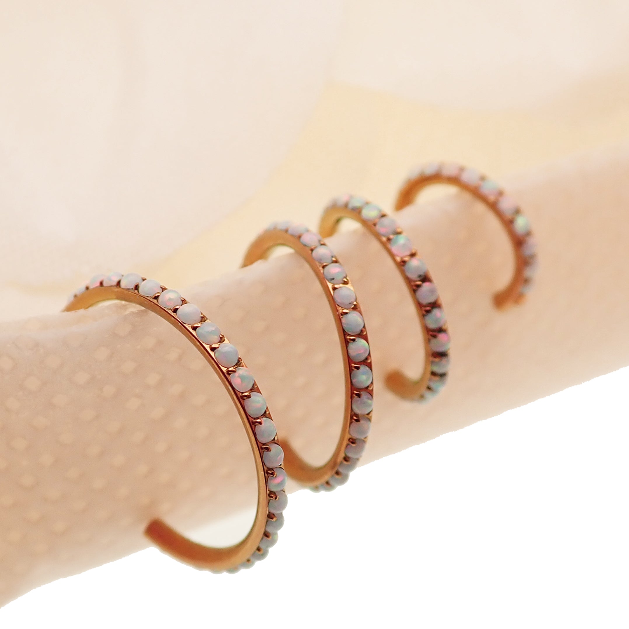 White fire opal titanium clicker body jewelry, 16g, with 6mm gemstones, from Body Clickers.