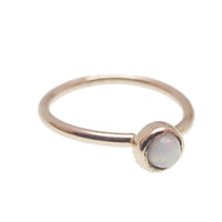 White opal 14k gold seamless body jewelry ring in 6mm and 8mm sizes, designed for body piercing adornment.
