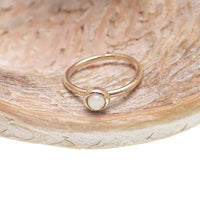 White opal seamless body jewelry ring in 14k gold, available in 6mm and 8mm sizes, by Body Clickers.