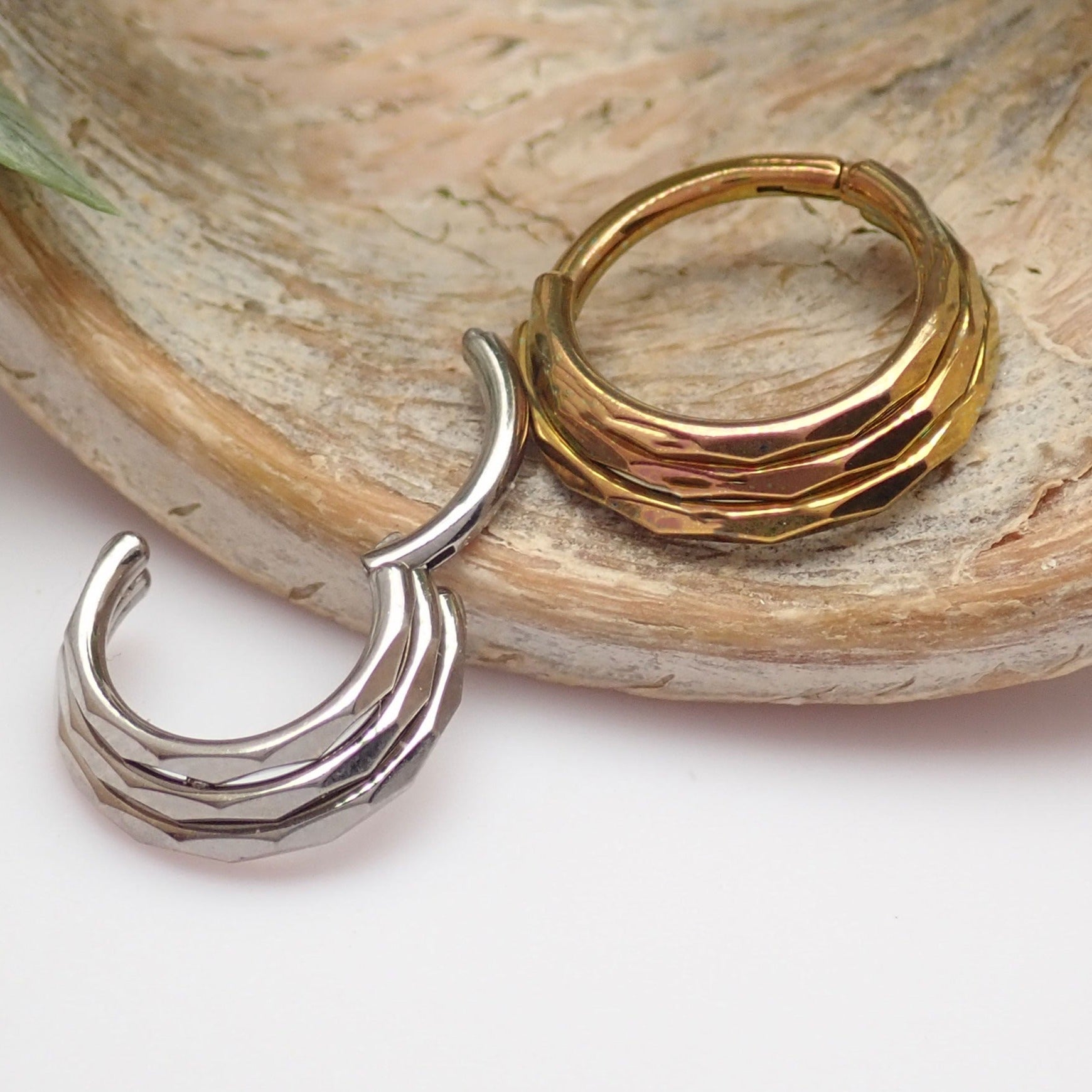 Three stacked beveled 16g Body Clickers body jewelry clicker with beveled edges and silver finish.