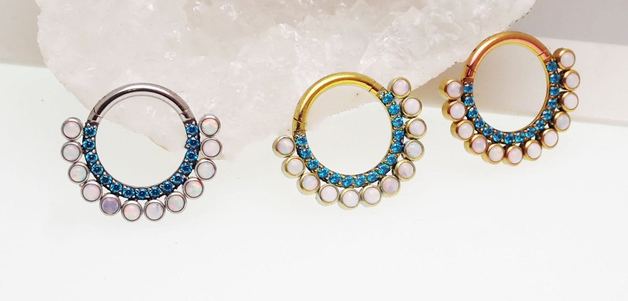 Blue zircon and white fire opal titanium clicker body jewelry in 16g with 8mm stones, designed for body piercing.