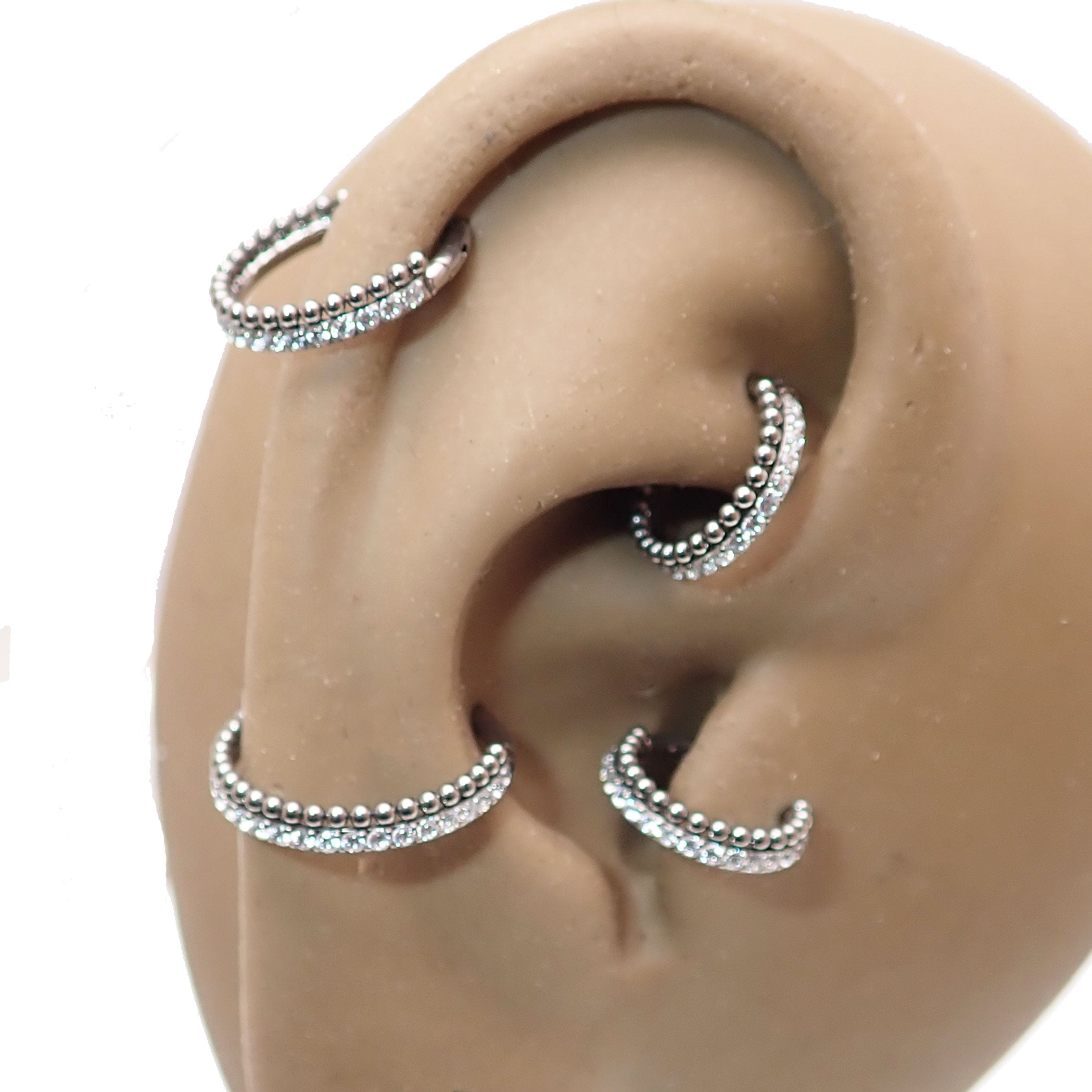 Clear crystal and bead titanium clicker body jewelry in 16g size from Body Clickers, featuring sparkling accents and smooth design.