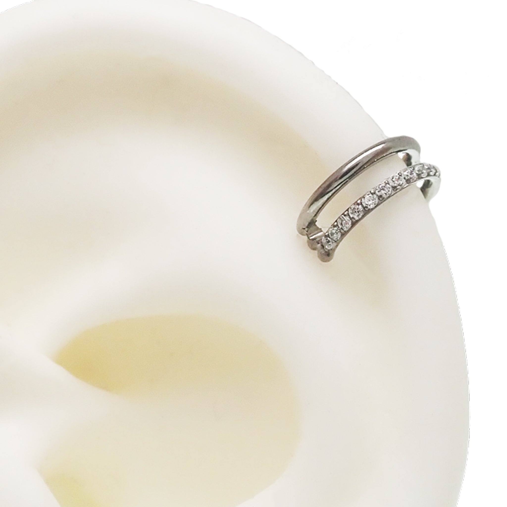 Clear CZ double row titanium clicker body jewelry in 16g with a sleek design, perfect for jewelry enthusiasts.
