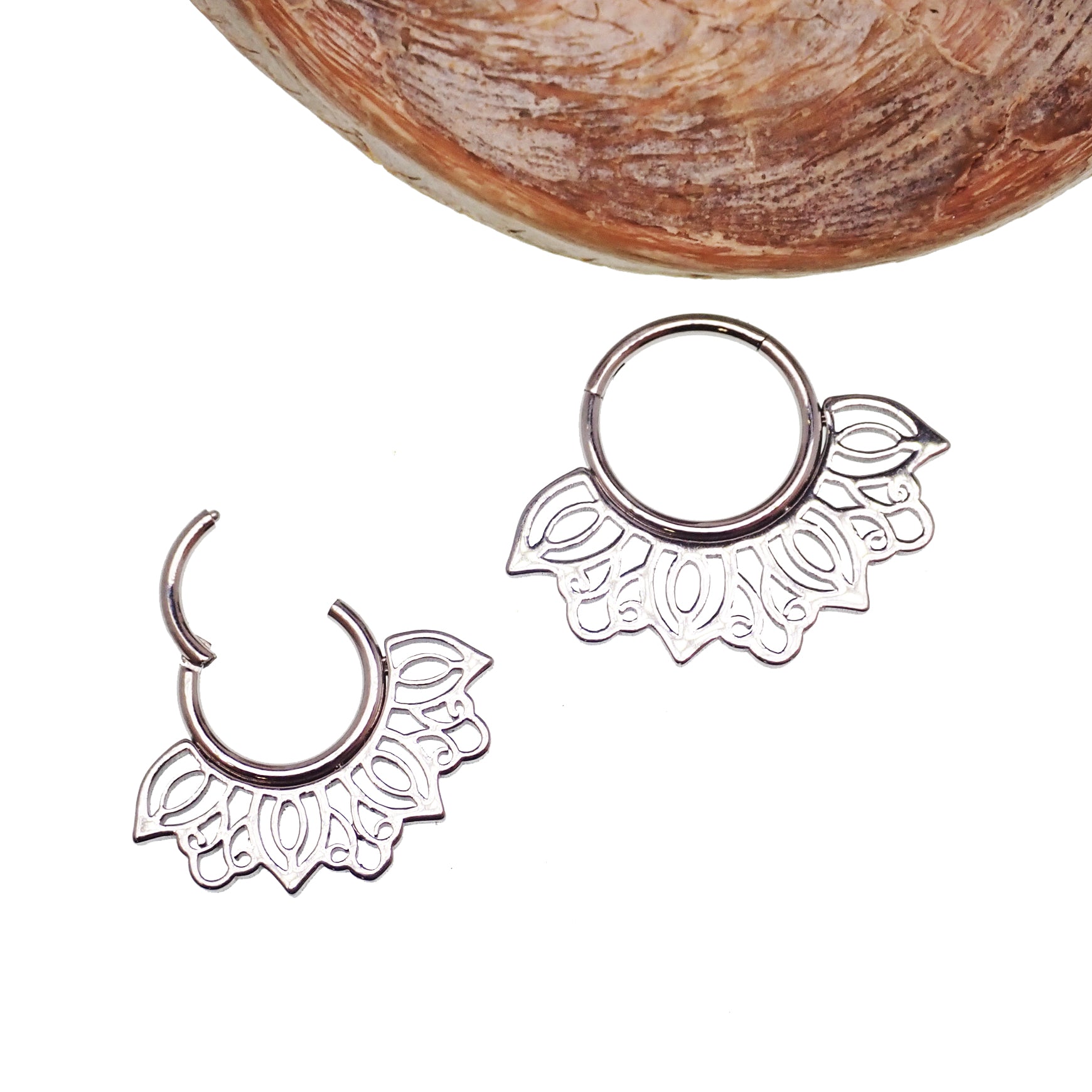 Filigree titanium clicker body jewelry in 16g with intricate design, featuring an 8mm opening for body piercing.