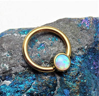 Gold and opal titanium CBR body jewelry by Body Clickers, featuring 8mm size with vibrant opal accents.