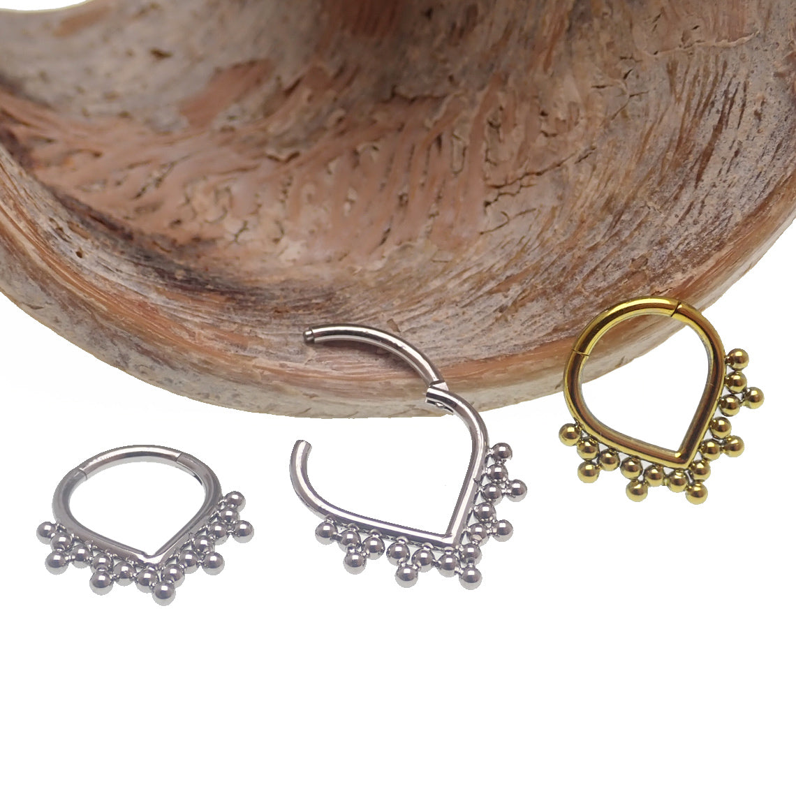 Heart-shaped beaded titanium clicker body jewelry in 16g with an 8mm design, featuring a stylish and comfortable body piercing accessory.