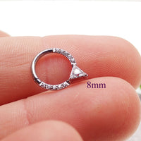 Hinged 16g Body Clicker body jewelry with triangle-shaped CZ accent, featuring a durable hinge and sleek design.