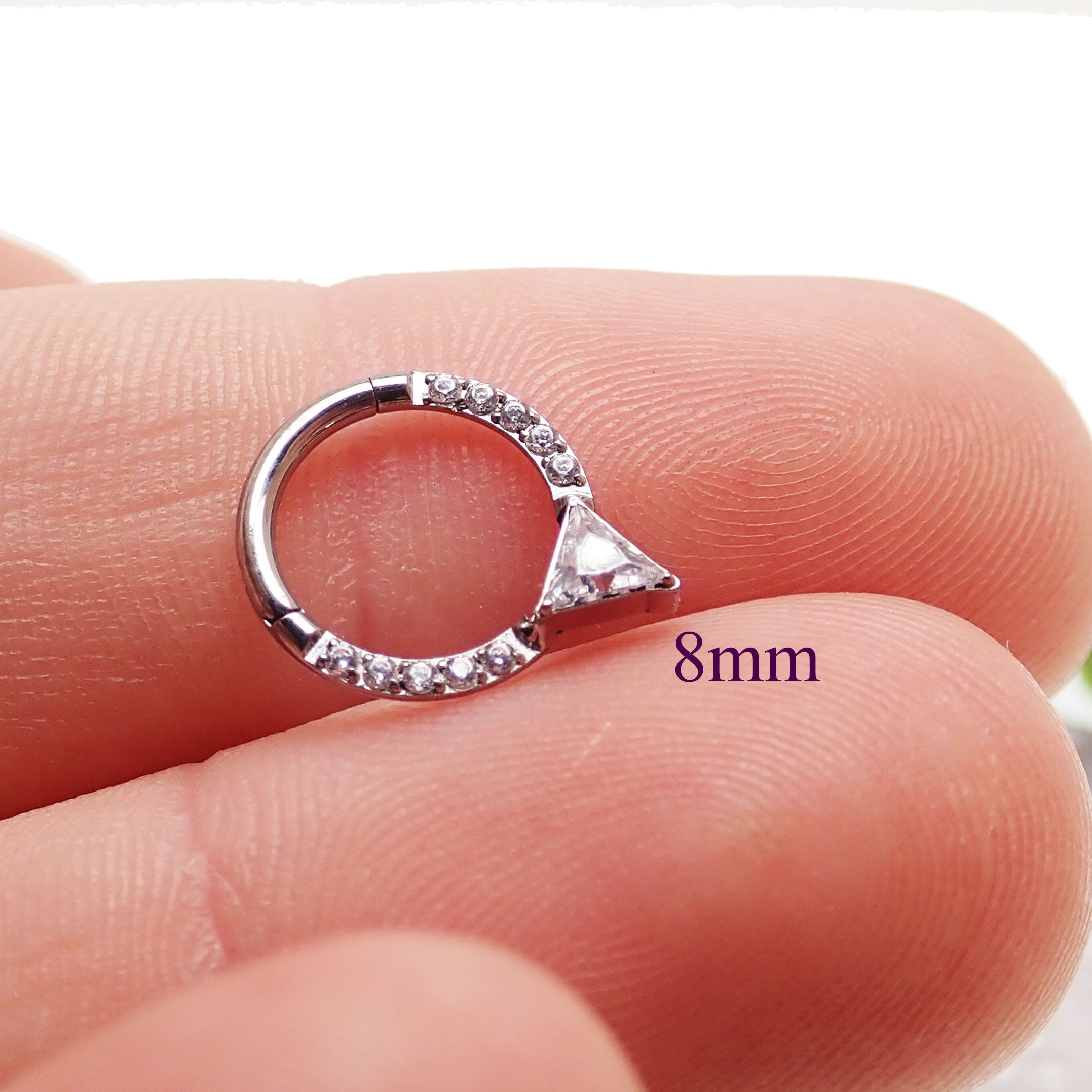 Hinged 16g Body Clicker body jewelry with triangle-shaped CZ accent, featuring a durable hinge and sleek design.