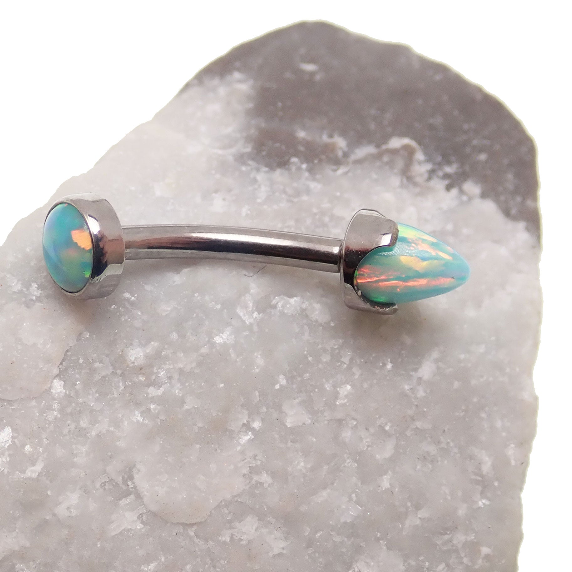 Curved opal spike barbell body jewelry with cabochon top, 14g, from Body Clickers, featuring a moon-yellow new style design.