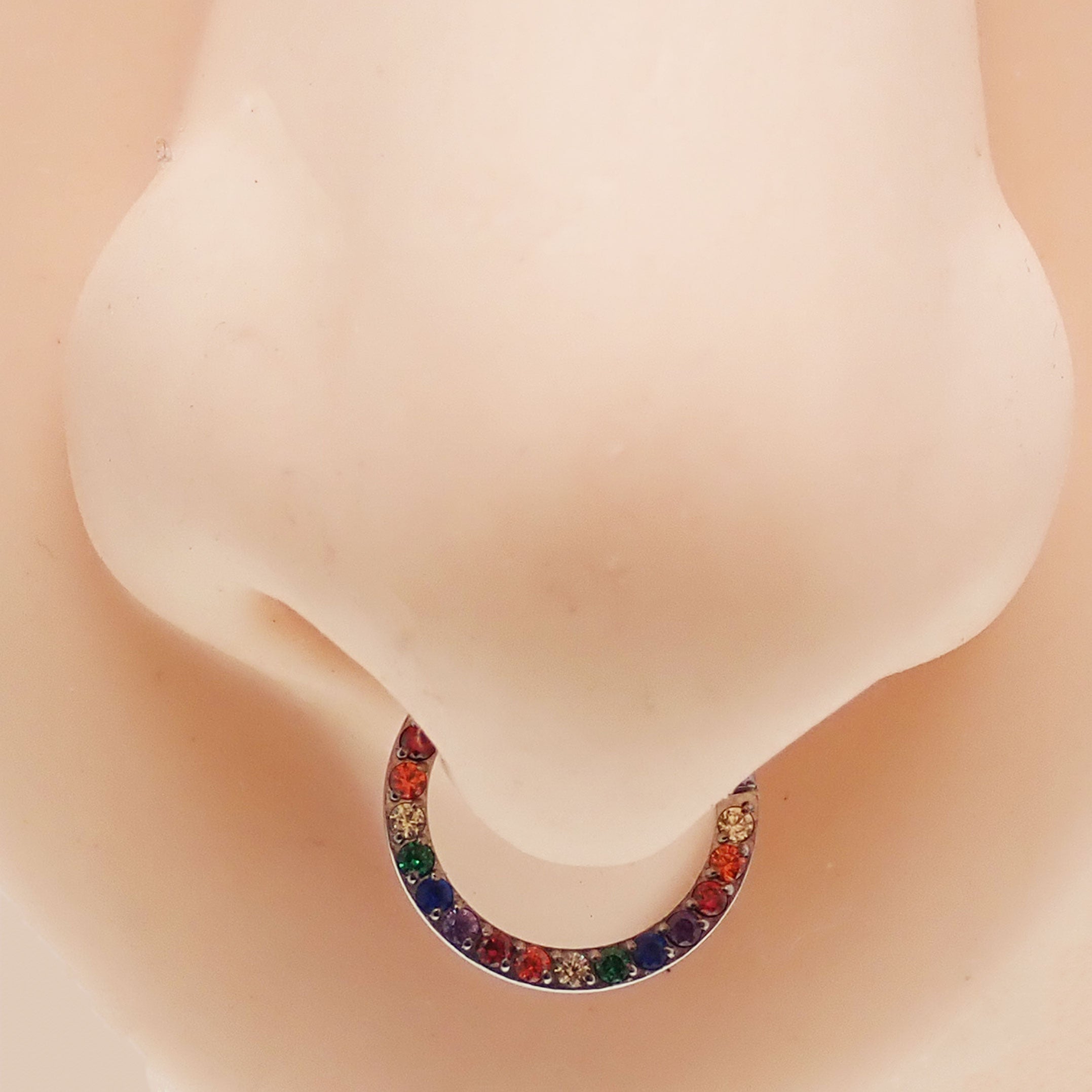 Multi-stone CZ titanium clicker body jewelry in 16g with an 8mm diameter, featuring colorful cubic zirconia stones.